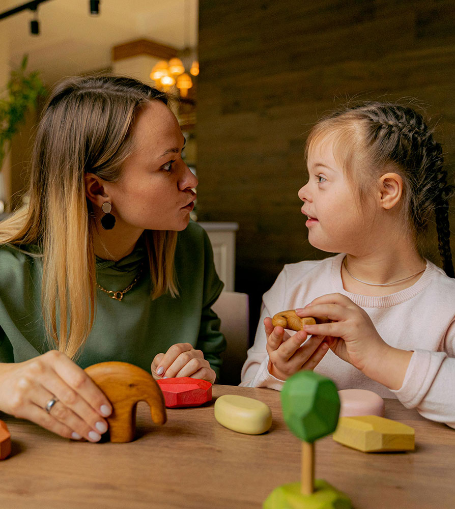 caregiver playing with a child with down syndrome