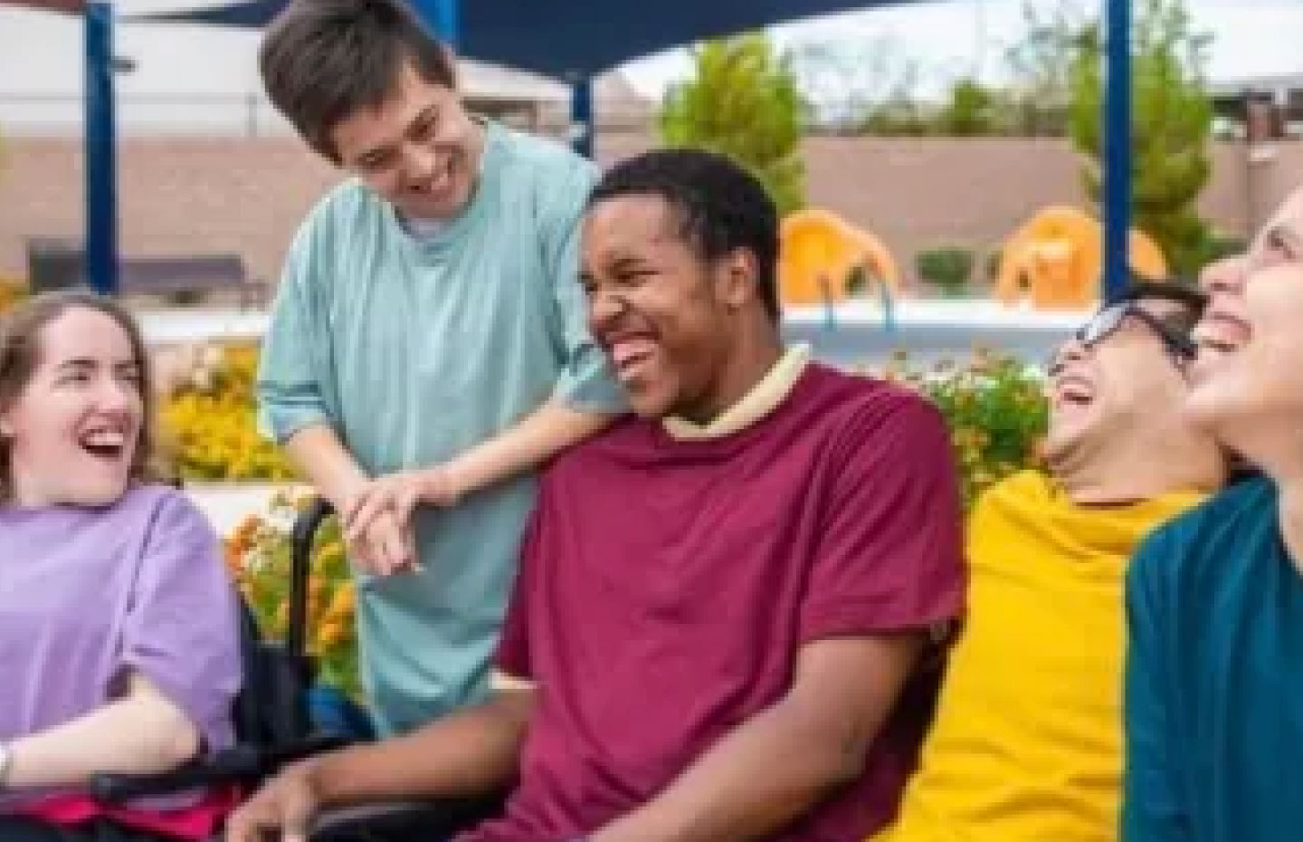 Group of friends with and without visual disabilities laughing outside