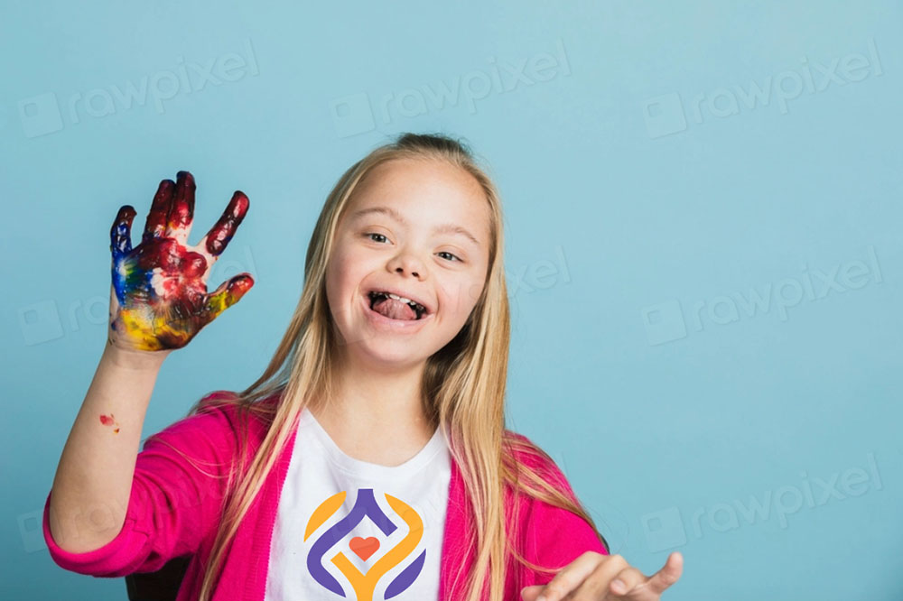 young girl wearing white always you signature logo tshirt & pink cardigan with paint on her hands